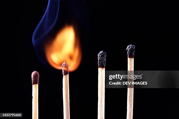 row of burning match sticks - matchstick ignition stock pictures, royalty-free photos & images