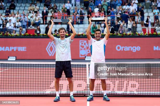 Maximo Gonzalez and Andres Molteni of Argentina celebrate with the trophy after winning match point against Nathaniel Lammons and Jackson Withrow of...