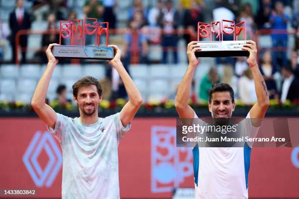 Maximo Gonzalez and Andres Molteni of Argentina celebrate with the trophy after winning match point against Nathaniel Lammons and Jackson Withrow of...