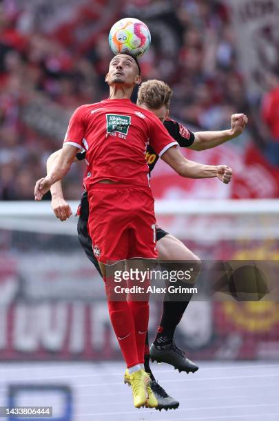 Kenny Redondo of Kaiserslautern jumps for a header with Scott Kennedy of Regensburg during the Second Bundesliga match between 1. FC Kaiserslautern...