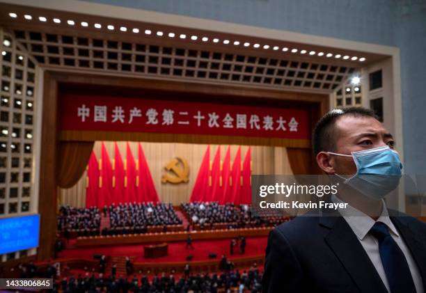 Security officer stands in the seating area after the Opening Ceremony of the 20th National Congress of the Communist Party of China at The Great...