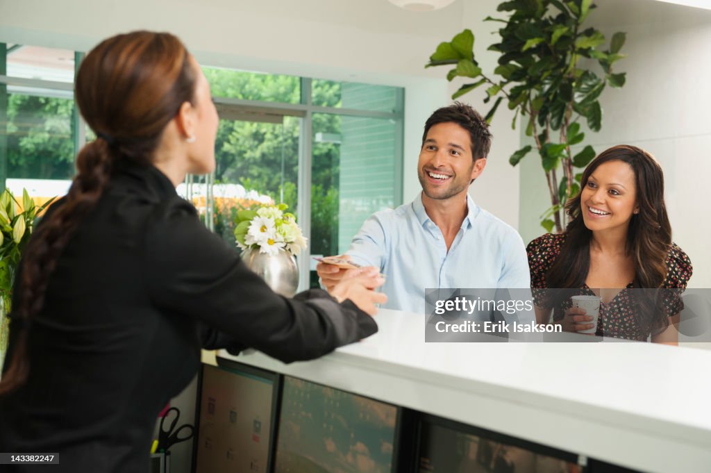 Couple checking in to hotel