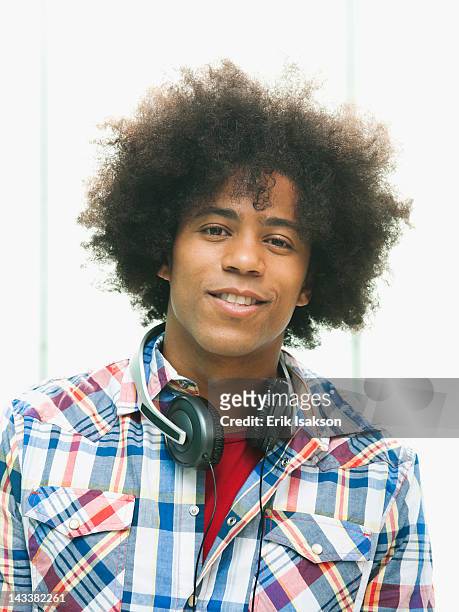 black man with headphones around neck - headphone man on neck stock-fotos und bilder