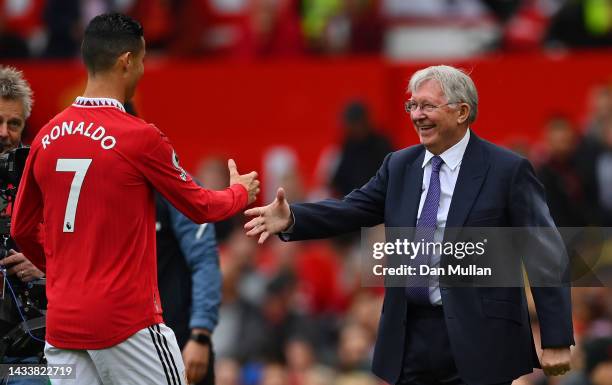 Cristiano Ronaldo of Manchester United is presented with an award for scoring 700 goals by Ex Manchester United Manager Sir Alex Ferguson prior tod...