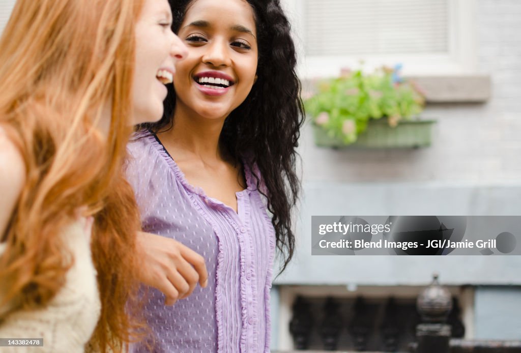 Smiling friends walking outdoors