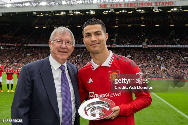 Former Manager Sir Alex Ferguson congratulates Cristiano Ronaldo of Manchester United on scoring his 700th club career goals ahead of the Premier...