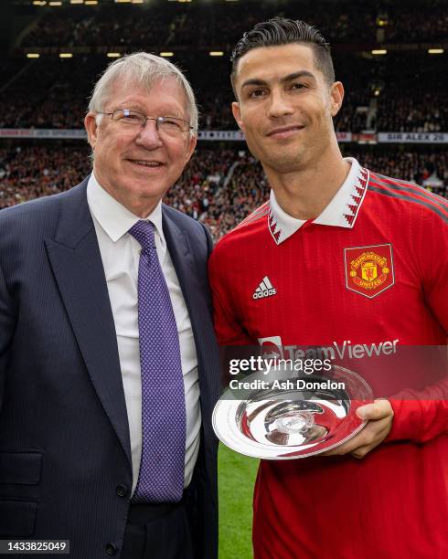 Former Manager Sir Alex Ferguson congratulates Cristiano Ronaldo of Manchester United on scoring his 700th club career goals ahead of the Premier...