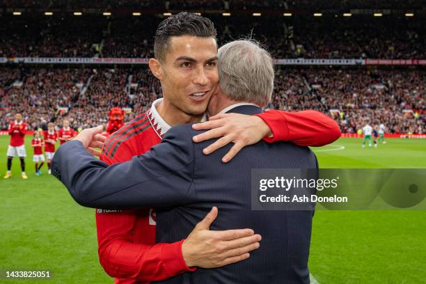 Former Manager Sir Alex Ferguson congratulates Cristiano Ronaldo of Manchester United on scoring his 700th club career goals ahead of the Premier...