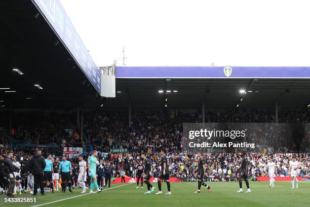Players of Leeds United and Arsenal head back into the tunnel as kick off is delayed due to a power outage at Elland Road during the Premier League...