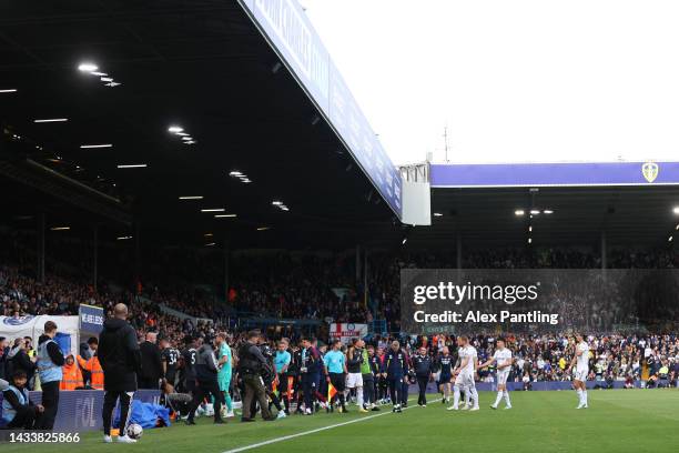 Players of Leeds United and Arsenal head back into the tunnel as kick off is delayed due to a power outage at Elland Road during the Premier League...