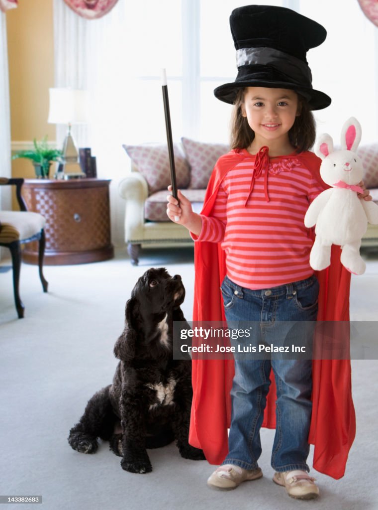 Caucasian girl dressed in magician's costume