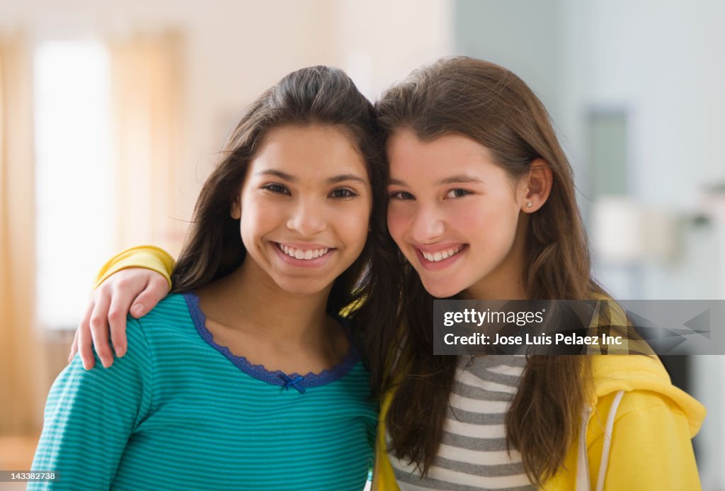 Smiling friends hugging