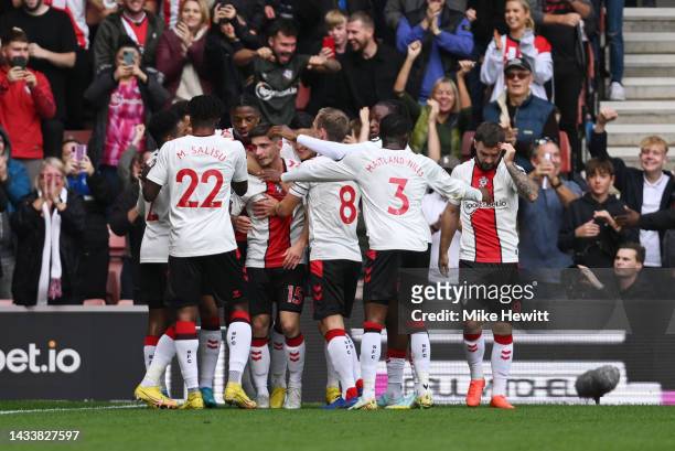 Romain Perraud of Southampton celebrates with their teammates after scoring their side's first goal during the Premier League match between...