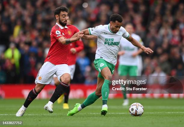 Jacob Murphy of Newcastle United is challenged by Bruno Fernandes of Manchester United during the Premier League match between Manchester United and...