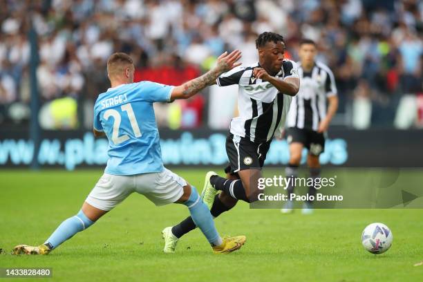 Destiny Udogie of Udinese Calcio is challenged by Sergej Milinkovic-Savic of SS Lazio during the Serie A match between SS Lazio and Udinese Calcio at...