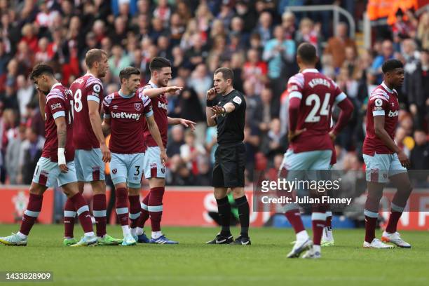 Match Referee, Peter Bankes is surrounded by West Ham United players after conceding during the Premier League match between Southampton FC and West...