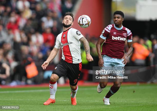 Adam Armstrong of Southampton is challenged by Ben Johnson of West Ham United during the Premier League match between Southampton FC and West Ham...