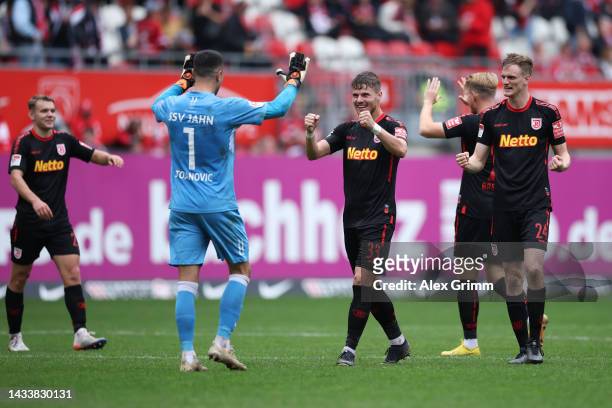 Players of Regensburg celebrate after the Second Bundesliga match between 1. FC Kaiserslautern and SSV Jahn Regensburg at Fritz-Walter-Stadion on...