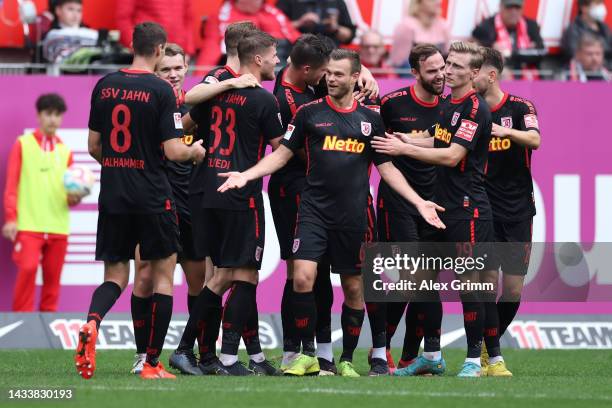 Prince Owusu of Regensburg celebrates their team's third goal with teammates during the Second Bundesliga match between 1. FC Kaiserslautern and SSV...