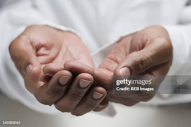 close up of mixed race man's hands - hands cupped empty stockfoto's en -beelden