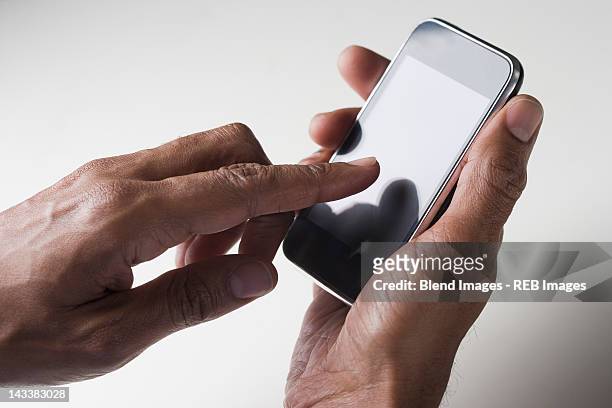 mixed race man text messaging on cell phone - hand receiving stock pictures, royalty-free photos & images