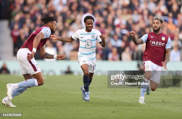 Raheem Sterling of Chelsea is challenged by Tyrone Mings and Douglas Luiz of Aston Villa during the Premier League match between Aston Villa and...