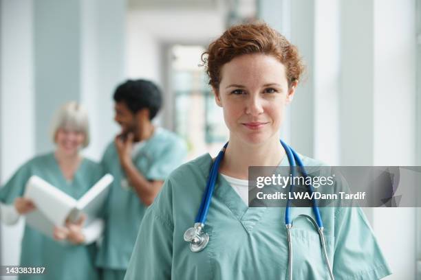 caucasian surgeon standing in hospital - nurse headshot stock pictures, royalty-free photos & images
