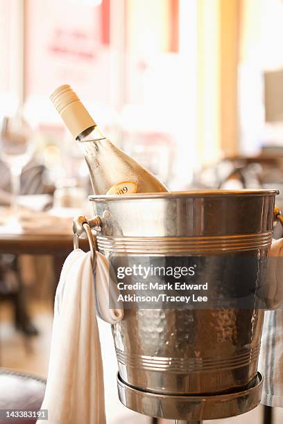 close up of white wine in ice bucket - ice bucket stockfoto's en -beelden