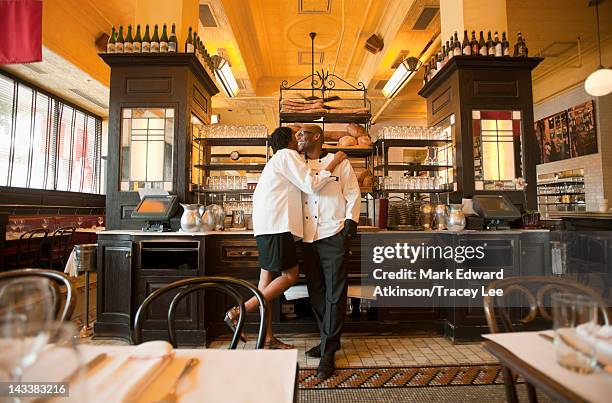 chef and waitress hugging in restaurant - richmond virginia stock pictures, royalty-free photos & images