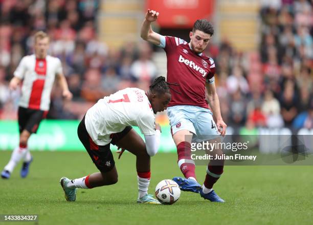 Joe Aribo of Southampton and Declan Rice of West Ham United battle for possession during the Premier League match between Southampton FC and West Ham...