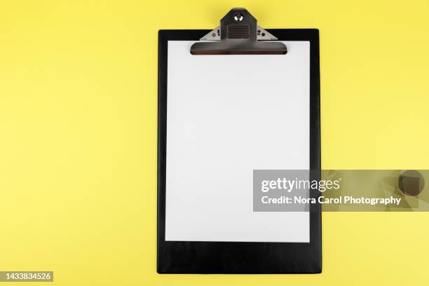 clipboard on yellow background - a4 paper stock pictures, royalty-free photos & images