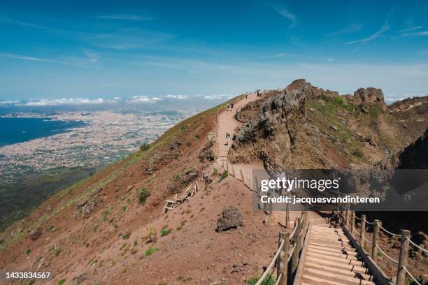 on the crater rim of vesuvius volcano with the city of naples (italy) in the background - mt vesuvius stock pictures, royalty-free photos & images