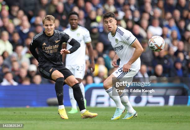 Martin Oedegaard of Arsenal is challenged by Marc Roca of Leeds United during the Premier League match between Leeds United and Arsenal FC at Elland...