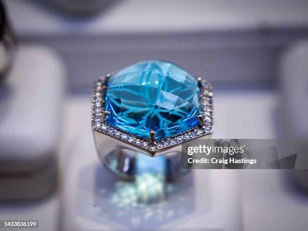 macro close up sapphire & topaz coloured gemstone set rings arranged in a row in jewellery store shop setting. luxury ring display with shining colourful stones and diamonds. high end luxury shopping. - gemstone ring stock pictures, royalty-free photos & images