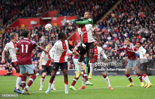 Gavin Bazunu of Southampton punches clear above teammate Mohammed Salisu during the Premier League match between Southampton FC and West Ham United...