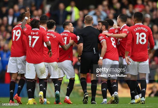 Manchester United players remonstrate with Referee, Craig Pawson following a booking for Cristiano Ronaldo of Manchester United during the Premier...
