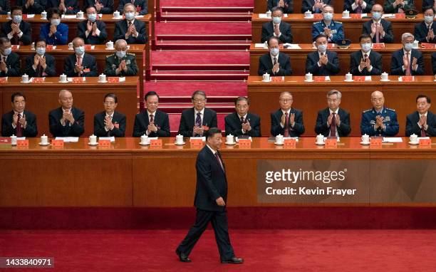 Chinese President Xi Jinping, bottom, is applauded by senior members of the government and delegates as he walks to the podium before his speech...