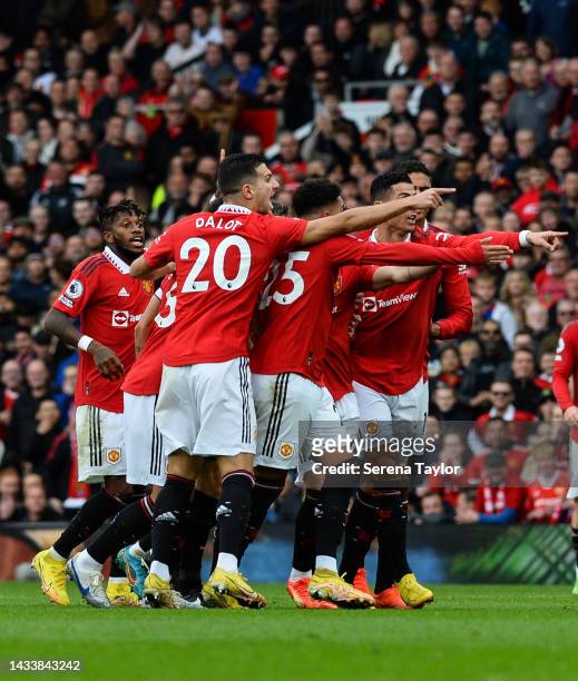 Manchester United players surround Referee Craig Pawson during the Premier League match between Manchester United and Newcastle United at Old...