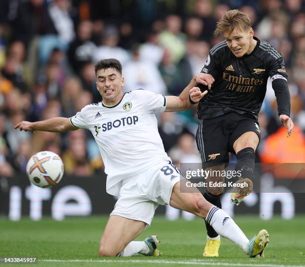 Martin Oedegaard of Arsenal shoots under pressure from Marc Roca of Leeds United during the Premier League match between Leeds United and Arsenal FC...