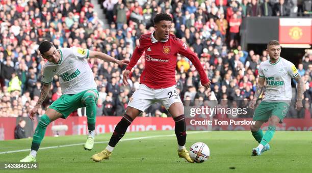 Jadon Sancho of Manchester United in action with Miguel Almiron of Newcastle United during the Premier League match between Manchester United and...