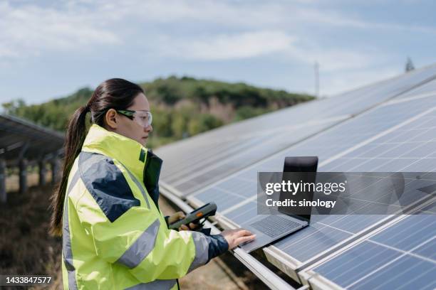 asian female employees working in solar power station - sustainable business stock pictures, royalty-free photos & images