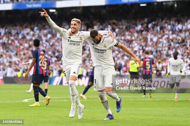 Federico Valverde of Real Madrid celebrates with teammate Karim Benzema after scoring their team's second goal during the LaLiga Santander match...