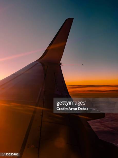 airplane window view during sunrise with airplane in the distance. - comfortable flight stock pictures, royalty-free photos & images