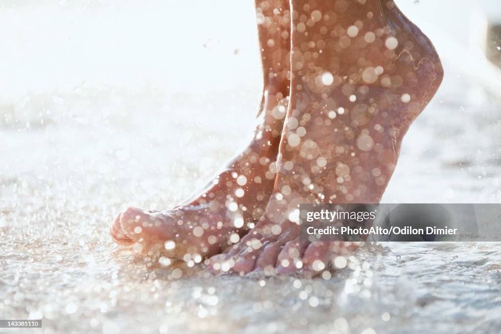 Feet under shower outdoors