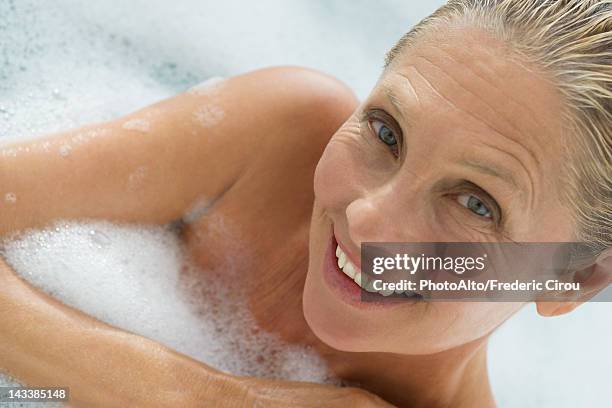 mature woman enjoying bubble bath, tilt - woman bath tub wet hair stock pictures, royalty-free photos & images