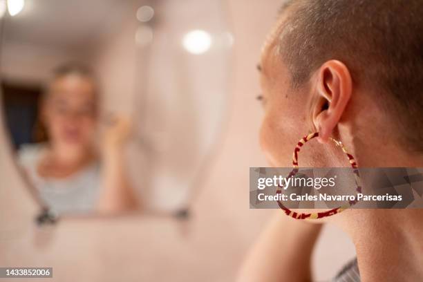 focus on heart shaped earrings that wearing a woman with cancer - oncology abstract stock pictures, royalty-free photos & images