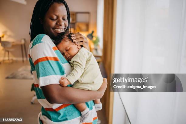 loving mom holding her baby - black mother and baby stock pictures, royalty-free photos & images