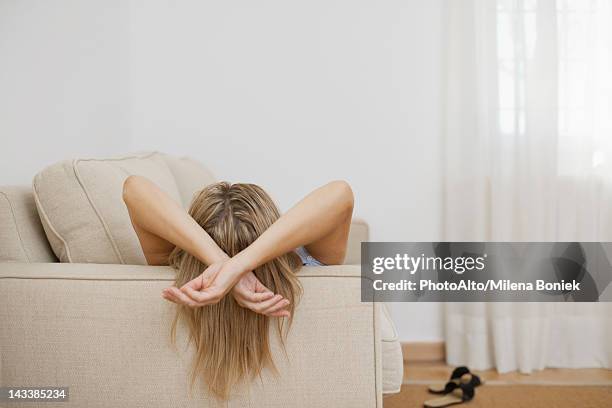 woman resting on sofa, rear view - lying on back ストックフォトと画像