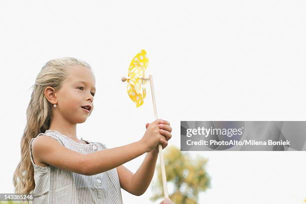 little girl holding pinwheel - 紙風車 ストックフォトと画像