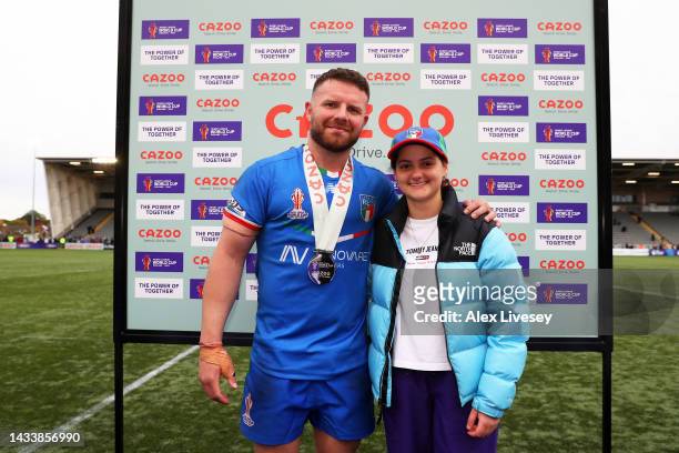 Nathan Brown of Italy poses alongside Cazoo Mascot after being named Player of the Match following the Rugby League World Cup 2021 Pool B match...